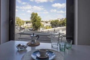 a table with a tea pot and glasses on a balcony at BigFamilyFlats - Vatican & Navona in Rome