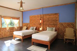 En eller flere senger på et rom på Mek Kiri Riverkwai Resort SHA