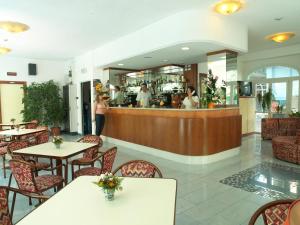 un ristorante con tavoli e sedie e un bar di Residence Eurogarden a Rimini