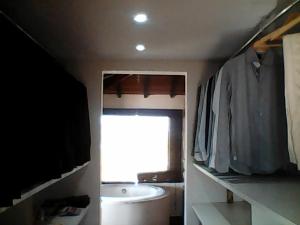 a bathroom with a sink and a toilet and a window at Villa Ferradura in Búzios +19 photos