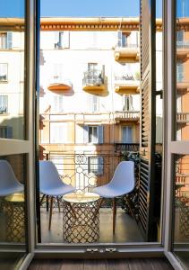 a view of a balcony with chairs and a window at Colors of Cinque Terre - Guest House in La Spezia