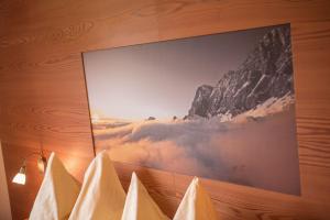 a picture on a wall with a picture of a mountain at Hinteregghof in Forstau