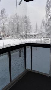 a view of a snow covered field from a window at City Apartment Pääsky in Rovaniemi +2 photos