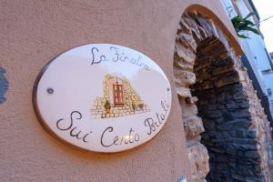 a sign for a cafe on the side of a building at La Finestra Sui Cento Portali in Pignola