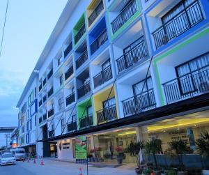 an apartment building with a blue and green facade at Suvarnabhumi Oriental Resort in Lat Krabang