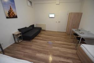 a living room with a couch and a table at Apartment Stuttgart Kaltental in Stuttgart