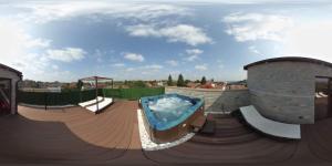 a hot tub on top of a wooden deck at Pensiunea El Passo Targu Mures in Târgu-Mureş