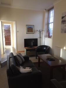 a living room with a couch and a table at The Feathers in Dersingham