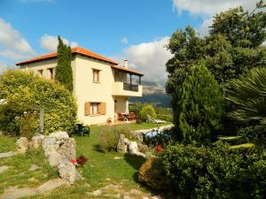 a house in the middle of a garden at Crete Family Villas in Pentamodi