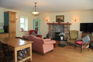 a living room filled with furniture and a fireplace at Glenboy Country Accommodation in Oldcastle
