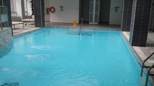 a large blue swimming pool in a building at 2 Bedroom 1 Bathroom Prime Location in Mississauga in Mississauga