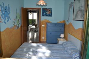 a bedroom with a bed and a blue dresser at Casa Teresa in Cavallino-Treporti