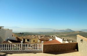 a view of a town from the balcony of a house at Casas Medina Güevéjar in Güevéjar