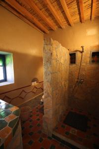 a bathroom with a stone shower in a building at Auberge Ibrahim in Agoudal