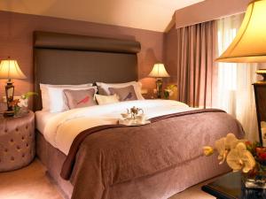 a bedroom with a large bed with a large headboard at The Old Bank Town House in Kinsale