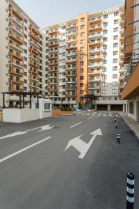 an empty parking lot in front of tall buildings at Orange Onix Apartaments in Bucharest