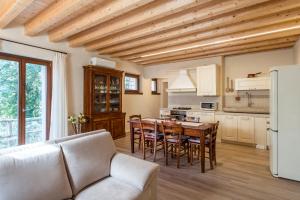 a kitchen and dining room with a table and chairs at Cascina La Scala in Salò