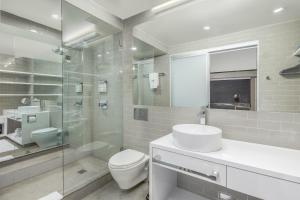 a bathroom with a toilet and a sink and a shower at Cachet Boutique Hotel NYC in New York