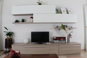 A television and/or entertainment centre at Vatican In The Moonlight Apartment