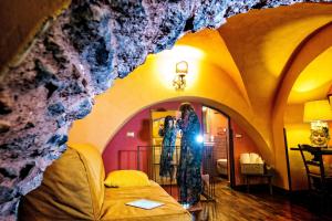 a woman is standing in a room in a cave at Cerami15 in Catania