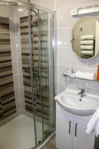 a bathroom with a shower and a sink at Wild Atlantic Accommodation 2G Orchard Crescent in Letterkenny