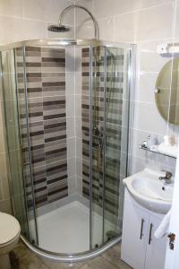 a bathroom with a shower and a sink at Wild Atlantic Accommodation 2G Orchard Crescent in Letterkenny