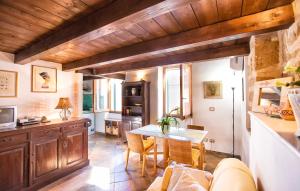 a kitchen with a table and chairs in a room at Emerald apartment in Alghero Historic Center in Alghero +50 photos