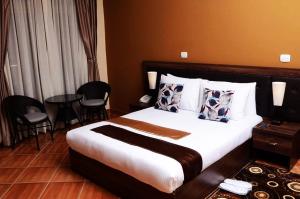 A bed or beds in a room at Heyday Hotel Addis Ababa