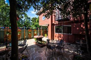 a patio with tables and chairs in front of a building at Hostel Chaman in Osorno