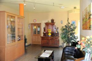 a living room with a wooden cabinet and a table at Gasthaus Hotel Feldschlange in Ried im Innkreis