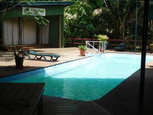 a large swimming pool in a yard with a wooden deck at Rainforest Eco Lodge in Suva