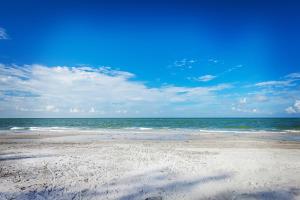 a sandy beach with the ocean in the background at Belleview Gulf Condos in Clearwater Beach