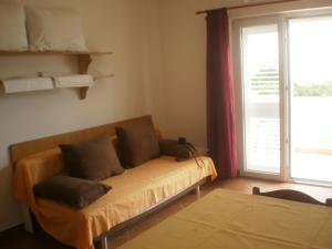 a living room with a couch and a window at Villa Ana in Bol
