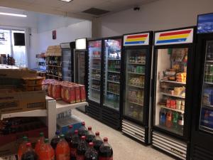 a store aisle with refrigerators and bottles of soda at Ocean Reserve STR-01045 in Sunny Isles Beach