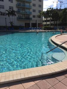 a large swimming pool with blue water in a building at Ocean Reserve STR-01045 in Sunny Isles Beach