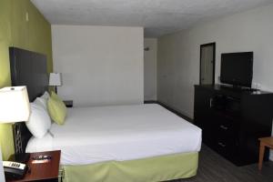 a hotel room with a bed and a television at Old Town Western Inn in San Diego