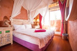 a bedroom with a large bed with a canopy at Kenting Afei Surf Hostel Nanwan in Nanwan