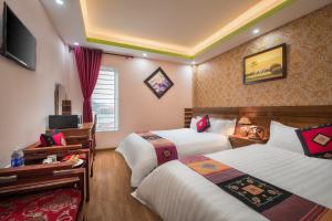 Postel nebo postele na pokoji v ubytování Sapa Luxury Hotel
