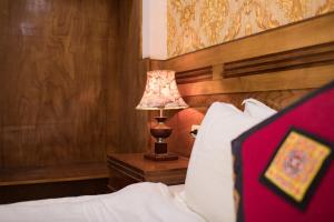 Postel nebo postele na pokoji v ubytování Sapa Luxury Hotel