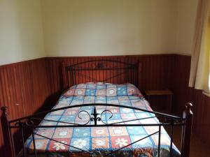 a bedroom with a bed with a blanket on it at Slalom Lodge in Raurimu Spiral