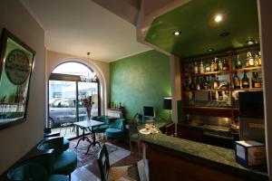 a bar in a restaurant with a table and chairs at Hotel La Meridiana in Anghiari