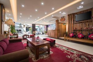 a living room with a couch and a table at Sapa Luxury Hotel in Sapa