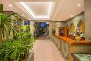 a hallway with potted plants in a building at Golden Temple Villa in Siem Reap +37 photos
