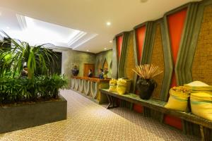 a lobby with potted plants in a building at Golden Temple Villa in Siem Reap