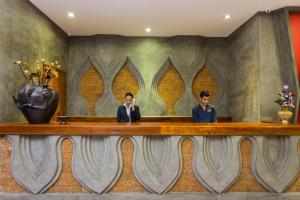 two men sitting at a table in a room at Golden Temple Villa in Siem Reap