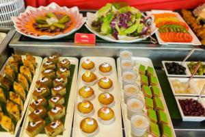 a buffet line with appetizers and plates of food at Golden Temple Villa in Siem Reap