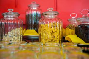 a table topped with glass jars filled with liquid at Golden Temple Villa in Siem Reap
