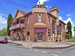 a large brick building on the corner of a street at Abermain Hotel in Abermain