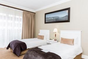 a hotel room with two beds and a window at Innscape Classic Hotel in Cape Town +24 photos