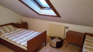 a bedroom with a bed and a skylight at Haus Jägersruh in Nagel